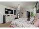 Charming main bedroom featuring an elegant chandelier, mounted TV, and stylish decor at 8937 Excelsior Loop, Venice, FL 34293