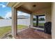 Cozy covered patio with brick flooring, ideal for outdoor entertaining and relaxing in your backyard at 8937 Excelsior Loop, Venice, FL 34293