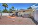 View of the gravel backyard with a grill and patio set with plenty of space at 1116 S Moonmist Ct # M12, Sarasota, FL 34242
