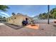 A gravel backyard includes a patio set, grill and small yard shed at 1116 S Moonmist Ct # M12, Sarasota, FL 34242