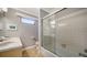 Bright bathroom featuring a tiled shower with glass doors and double sink vanity at 1116 S Moonmist Ct # M12, Sarasota, FL 34242