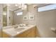Bathroom with a double sink vanity, large mirror, and neutral color scheme at 1116 S Moonmist Ct # M12, Sarasota, FL 34242