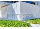 Close-up of the Siesta Beach building showing modern architectural details and surrounding vegetation at 1116 S Moonmist Ct # M12, Sarasota, FL 34242