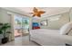 Cozy bedroom with a sliding glass door to a patio, ceiling fan, and neutral decor at 1116 S Moonmist Ct # M12, Sarasota, FL 34242