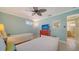 Comfortable bedroom with twin beds, large TV, and view of the en-suite bathroom at 1116 S Moonmist Ct # M12, Sarasota, FL 34242