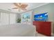 Bedroom featuring a bed, TV, ceiling fan, closet and neutral decor at 1116 S Moonmist Ct # M12, Sarasota, FL 34242