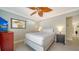 Comfortable bedroom featuring a bed, TV, ceiling fan and neutral decor at 1116 S Moonmist Ct # M12, Sarasota, FL 34242
