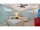 Light-filled bedroom with two twin beds, ceiling fan, and coastal-themed decor at 1116 S Moonmist Ct # M12, Sarasota, FL 34242
