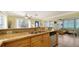 Bright kitchen with stainless steel appliances, granite counters, and an open layout to the living area at 1116 S Moonmist Ct # M12, Sarasota, FL 34242