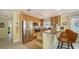 Kitchen with stainless steel appliances, breakfast bar and maple cabinets at 1116 S Moonmist Ct # M12, Sarasota, FL 34242