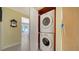 Convenient laundry closet featuring a stacked washer and dryer at 1116 S Moonmist Ct # M12, Sarasota, FL 34242