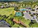 Aerial view of community amenities including a pool, clubhouse, playground, and basketball court at 11324 77Th E St, Parrish, FL 34219