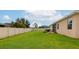 Spacious backyard with lush green grass, a white fence, and mature trees for privacy at 11324 77Th E St, Parrish, FL 34219