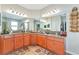 Bright bathroom featuring double sinks, granite countertops, and wooden cabinets at 11324 77Th E St, Parrish, FL 34219