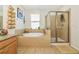 Relaxing bathroom with a soaking tub, separate shower, and tile surround at 11324 77Th E St, Parrish, FL 34219
