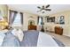 Cozy bedroom with lots of artwork, a ceiling fan, and natural light at 11324 77Th E St, Parrish, FL 34219