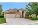 Charming single-story home with a three-car garage and lush landscaping, offering curb appeal at 11324 77Th E St, Parrish, FL 34219