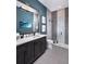 Bathroom with shaker cabinets, stone countertops, and a glass-enclosed shower at 1162 Blue Shell Loop, Sarasota, FL 34240