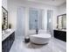 Spa-like bathroom with a freestanding tub, walk-in shower, and dual vanities at 1162 Blue Shell Loop, Sarasota, FL 34240