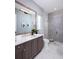 Bathroom featuring double vanity with stone countertops and glass enclosed shower at 1162 Blue Shell Loop, Sarasota, FL 34240