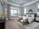 Light-filled bedroom with water view, tray ceiling, and modern decor at 1162 Blue Shell Loop, Sarasota, FL 34240
