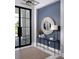 Stylish foyer featuring a console table, round mirror, and modern lighting at 1162 Blue Shell Loop, Sarasota, FL 34240