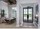 Elegant foyer with double doors and a view into the dining room at 1162 Blue Shell Loop, Sarasota, FL 34240