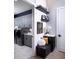 Bright laundry room with gray cabinets, white counters, modern appliances, and stylish decor at 1162 Blue Shell Loop, Sarasota, FL 34240