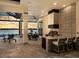 Stylish outdoor kitchen and dining area with waterfront views, bar seating, and built-in grill at 1162 Blue Shell Loop, Sarasota, FL 34240