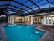 Expansive screened-in pool and patio area, perfect for outdoor living and entertaining with beautiful lighting at 1162 Blue Shell Loop, Sarasota, FL 34240