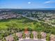 Beautiful aerial view of a residential area with lake views and lush greenery, indicating proximity to water and nature at 1301 Backspin Dr, Englewood, FL 34223
