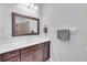 Bright bathroom featuring a walk-in shower with glass partition and dark wood vanity at 1301 Backspin Dr, Englewood, FL 34223