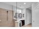 Bright bathroom featuring a walk-in shower with glass partition and dark wood vanity at 1301 Backspin Dr, Englewood, FL 34223