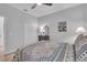 Bright bedroom featuring a ceiling fan, closet, and framed artwork at 1301 Backspin Dr, Englewood, FL 34223