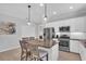 Bright kitchen with granite countertops, stainless steel appliances, island seating, and recessed lighting at 1301 Backspin Dr, Englewood, FL 34223