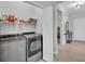 Convenient laundry room with modern appliances and ample storage space, near the main entrance of the house at 1301 Backspin Dr, Englewood, FL 34223