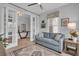 Inviting living room with comfortable seating, a large rug, and a view to the next room at 1301 Backspin Dr, Englewood, FL 34223