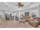 Open living room showcases neutral furniture, ceiling fan, and seamless flow into the dining area at 1301 Backspin Dr, Englewood, FL 34223