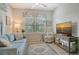 Cozy living room filled with natural light from the bright, sunny window at 1301 Backspin Dr, Englewood, FL 34223