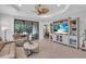 Open living room features a TV, ceiling fan, sliding glass doors to the lanai, and neutral interior at 1301 Backspin Dr, Englewood, FL 34223