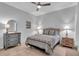 Comfortable bedroom with a ceiling fan, window and matching nightstands at 1301 Backspin Dr, Englewood, FL 34223