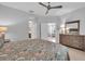 Comfortable bedroom with a ceiling fan, window and matching nightstands at 1301 Backspin Dr, Englewood, FL 34223