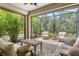 Screened patio with comfortable seating and lush, tropical landscaping at 1301 Backspin Dr, Englewood, FL 34223
