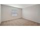 Cozy bedroom features plush carpeting and natural light from the window at 13125 Bayberry Way, Parrish, FL 34219