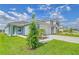 Beautiful, contemporary home with well manicured lawn and bright blue paint at 13125 Bayberry Way, Parrish, FL 34219
