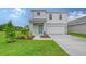 Charming two-story home featuring a well-manicured lawn and a welcoming blue front door at 13129 Bayberry Way, Parrish, FL 34219