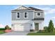 Charming two-story home with attached two car garage, green door, and front lawn landscaping at 13133 Bayberry Way, Parrish, FL 34219