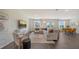 Bright, open-concept living room with modern furnishings, neutral tones, and hardwood flooring at 13133 Bayberry Way, Parrish, FL 34219