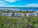 Aerial view of waterfront condos with canals and lush green surroundings, offering privacy at 1316 Perico Point Cir, Bradenton, FL 34209