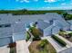 An aerial view of townhouses with attached garages, landscaped yards, and green foliage at 1316 Perico Point Cir, Bradenton, FL 34209
